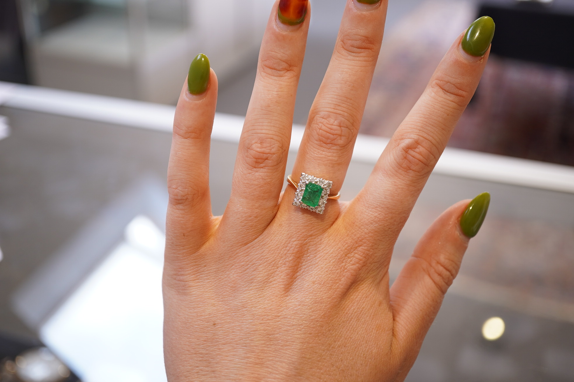 An emerald and diamond ring